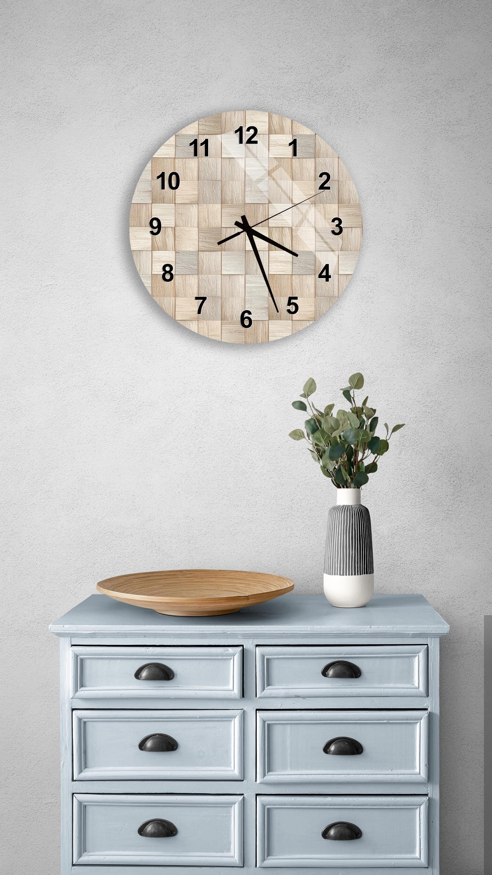 a light blue wooden dresser with a round clock mounted on the wall above it. The dresser has six drawers and a vase with greenery on top.