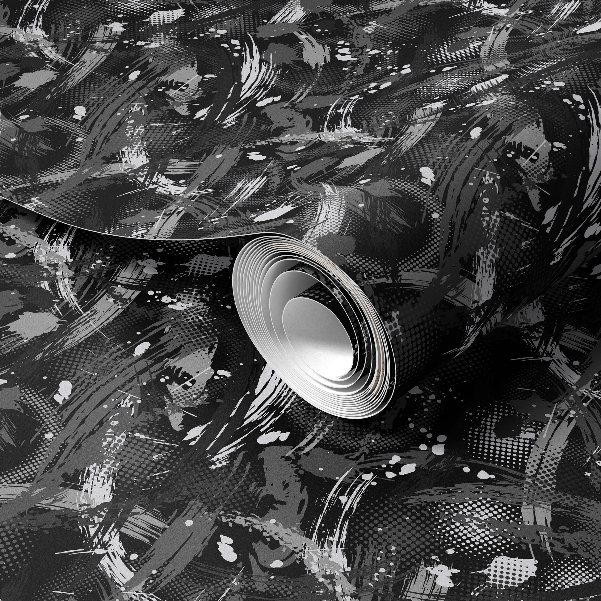 The image is a black and white abstract artwork with a textured, brush-like pattern. The central focus is a large, circular shape that appears to be made of paper or fabric, with a white center and a black, textured background.