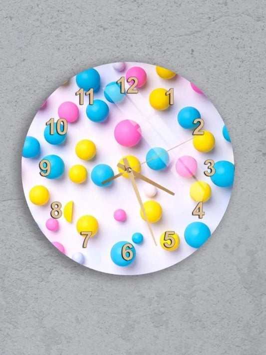 six colorful clocks with various designs and patterns, including balloons and numbers, mounted on a gray wall.