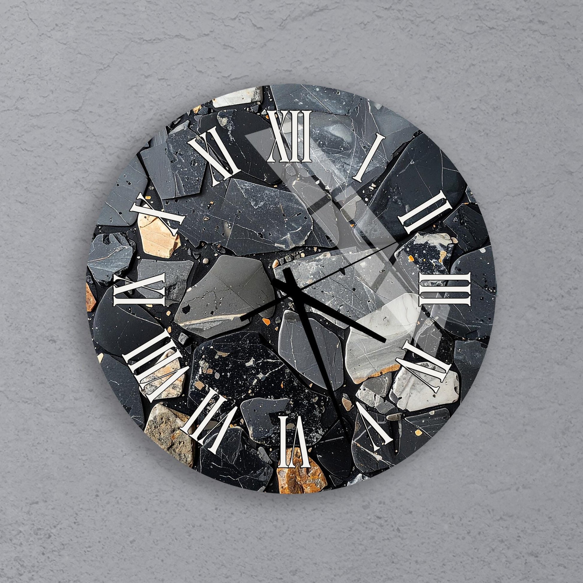 a clock with a unique design made of black and white rocks and minerals, creating a striking contrast against the gray background.