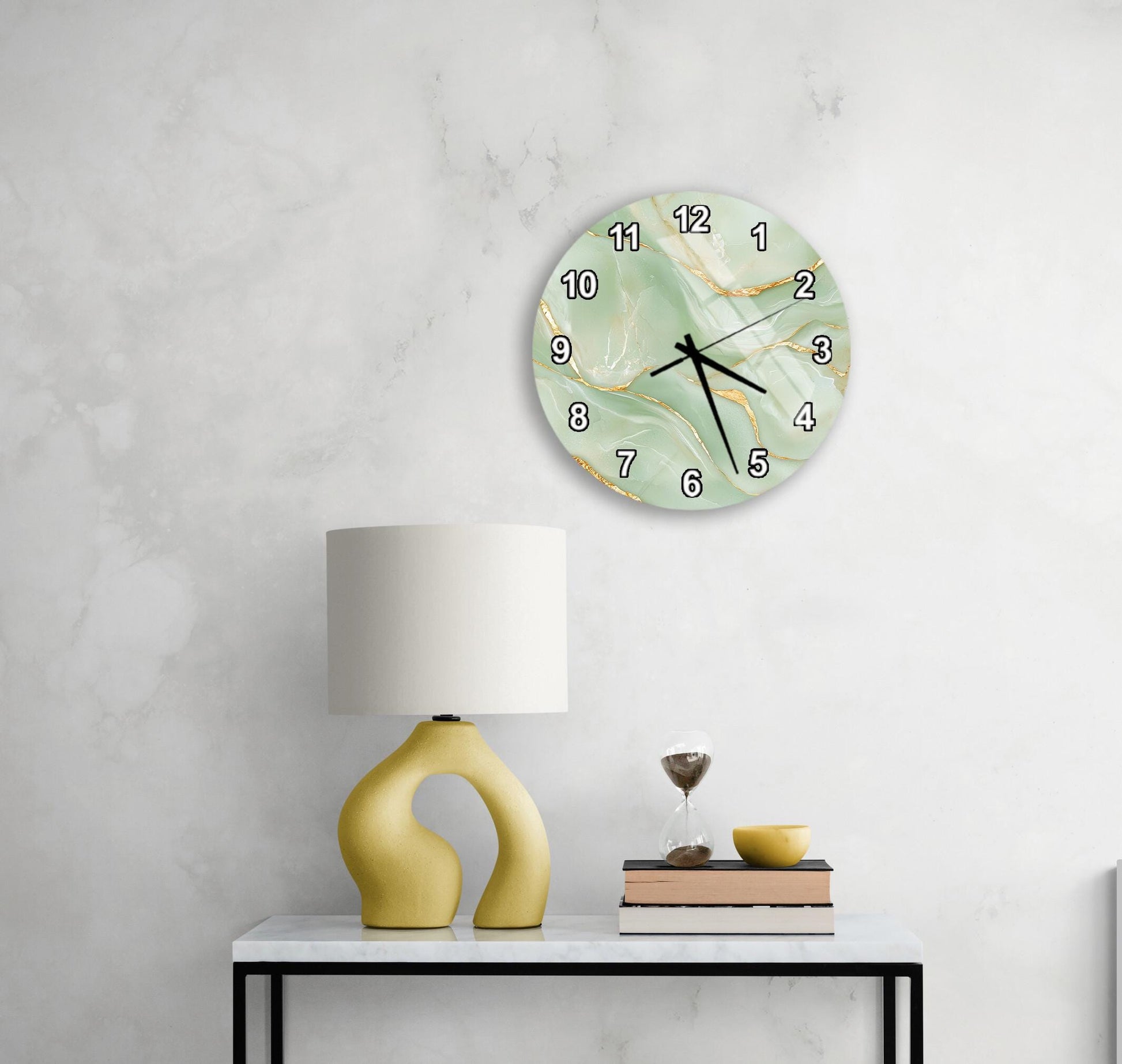 a white wall with a round clock displaying the time as 12:05, and a yellow lamp with a curved base on a white table.