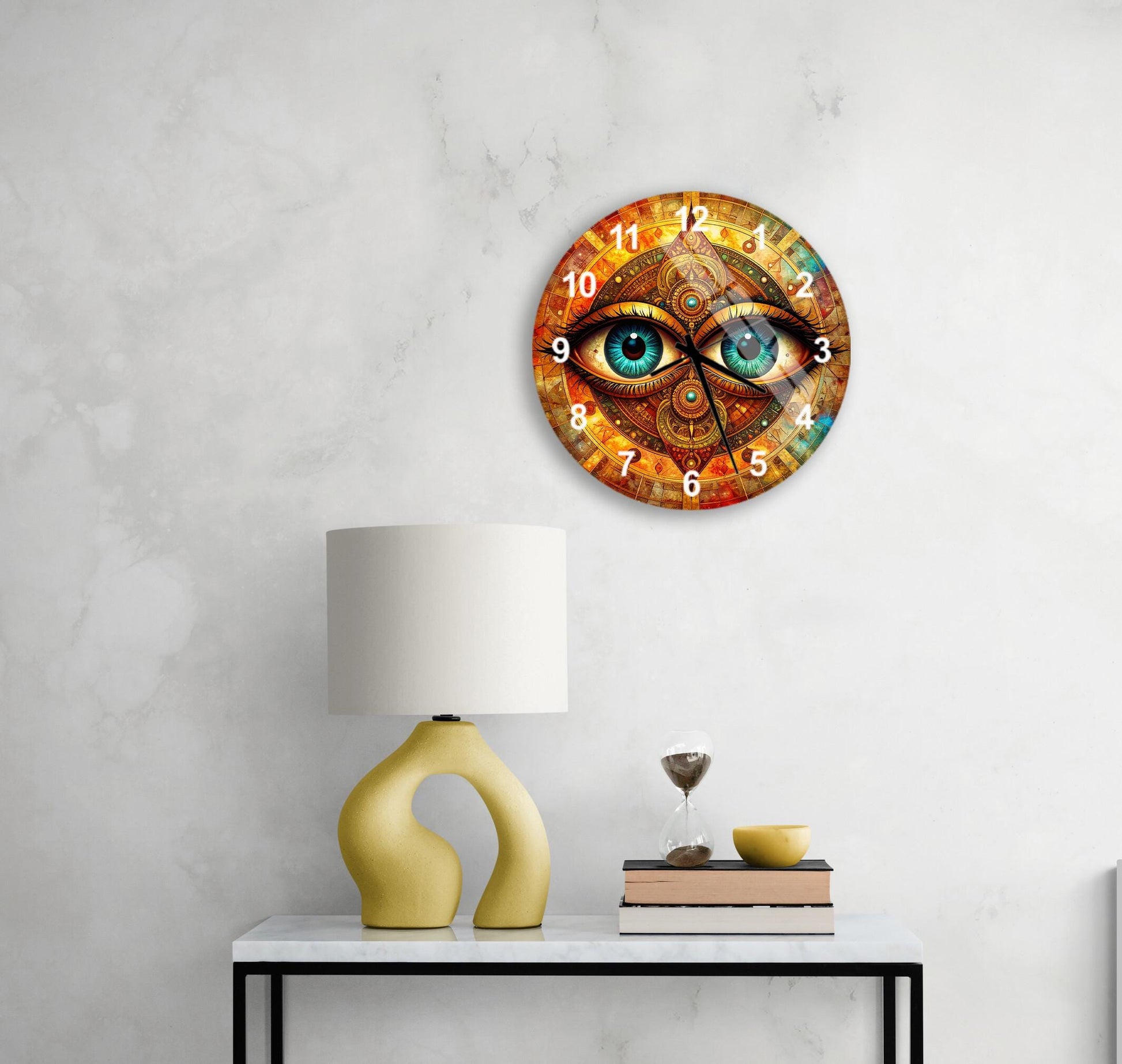 a wall clock with a unique design, a yellow table lamp, a stack of books, and a glass of water on a white table.