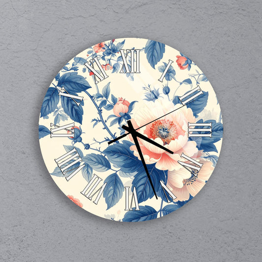 A round wall clock with a floral design featuring blue and pink flowers and leaves.