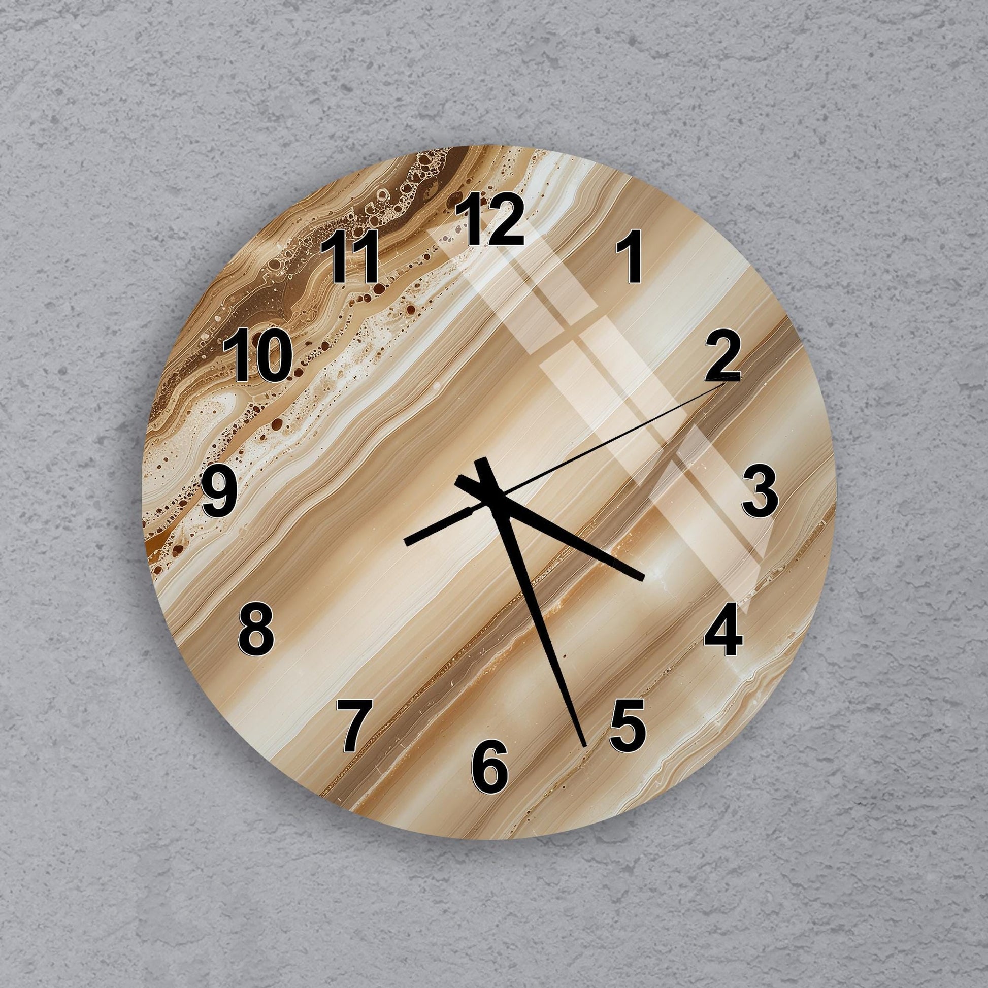 A wall clock with a marble-like design on its face, displaying the time as approximately 10:10.