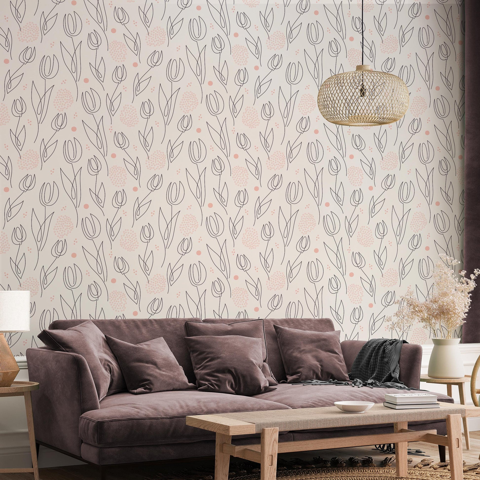 a living room with a brown sofa, a wooden coffee table, and a decorative pendant light hanging above the sofa. The wall behind the sofa has a repeating pattern of pink and white flowers, creating a visually appealing and cozy atmosphere.