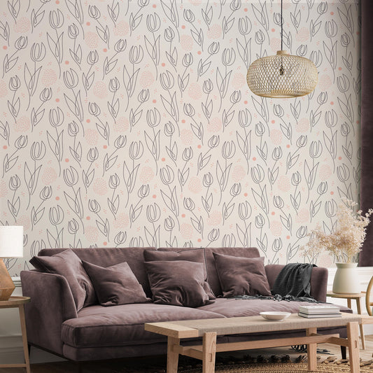a living room with a brown sofa, a wooden coffee table, and a decorative pendant light hanging above the sofa. The wall behind the sofa has a repeating pattern of pink and white flowers, creating a visually appealing and cozy atmosphere.
