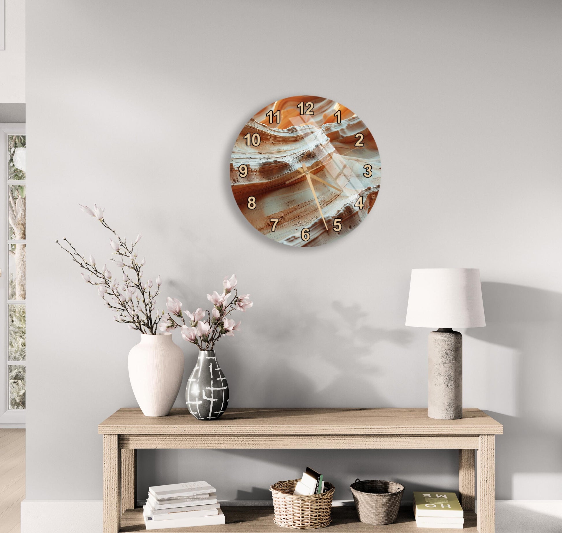 a modern living room with a wooden console table, a round wall clock with a unique abstract design, and various decorative items such as a vase with flowers, a lamp, and a stack of books.