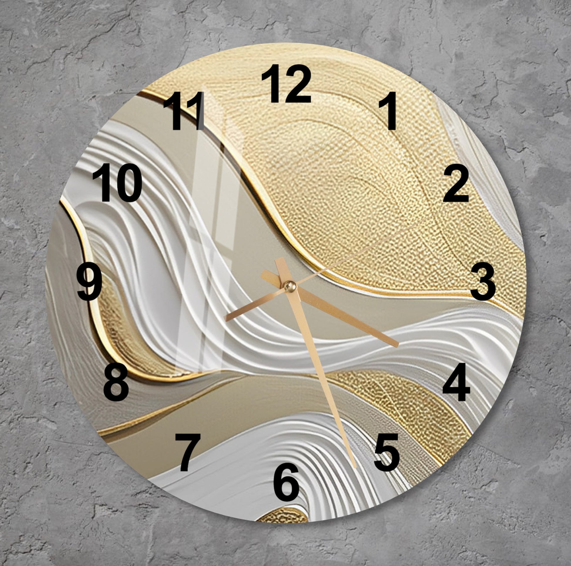 a gold and white clock on a gray wall