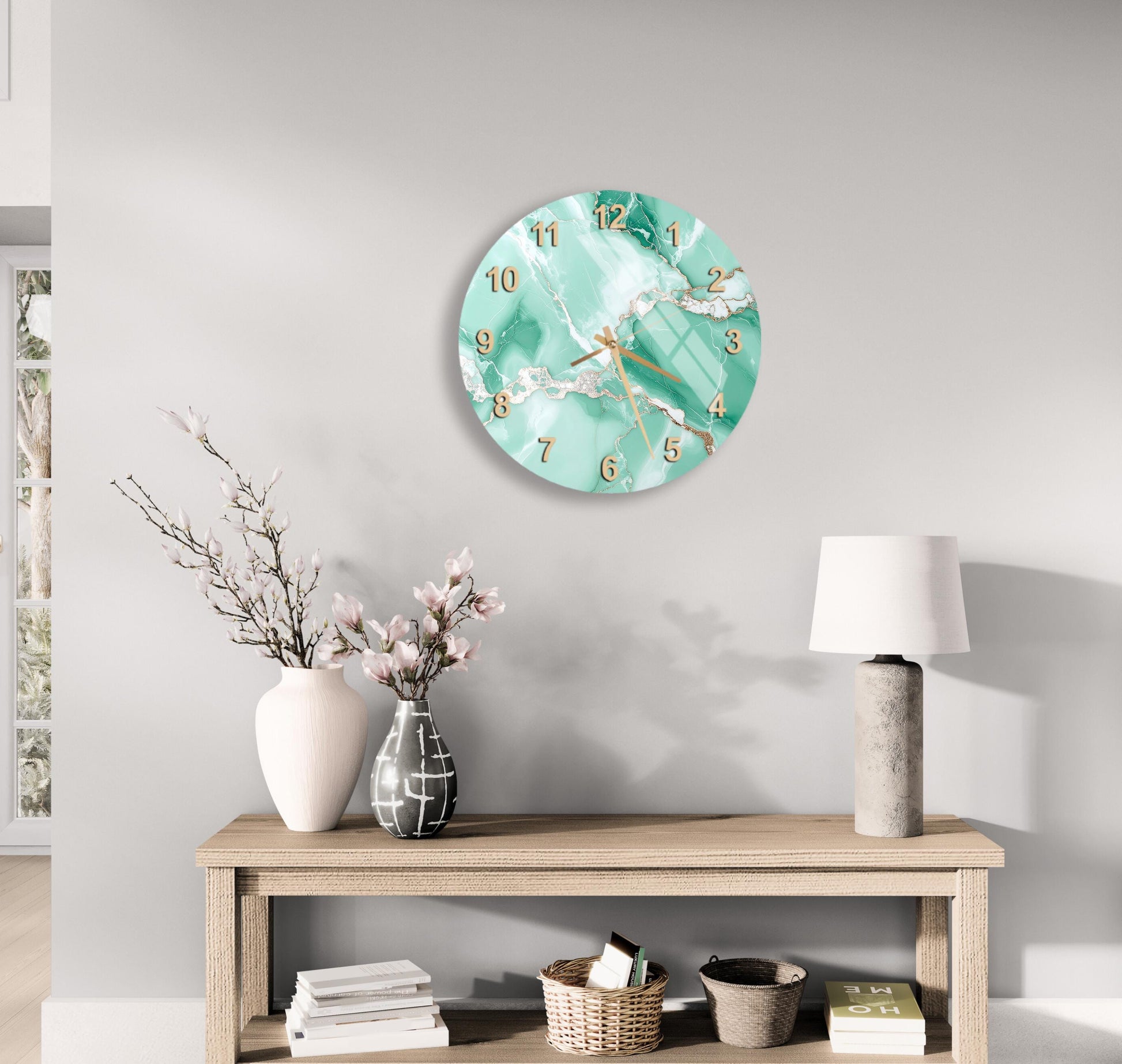 a modern living room with a round wall clock displaying the time as 12:30, a wooden table with a lamp, a vase with flowers, and a stack of books.