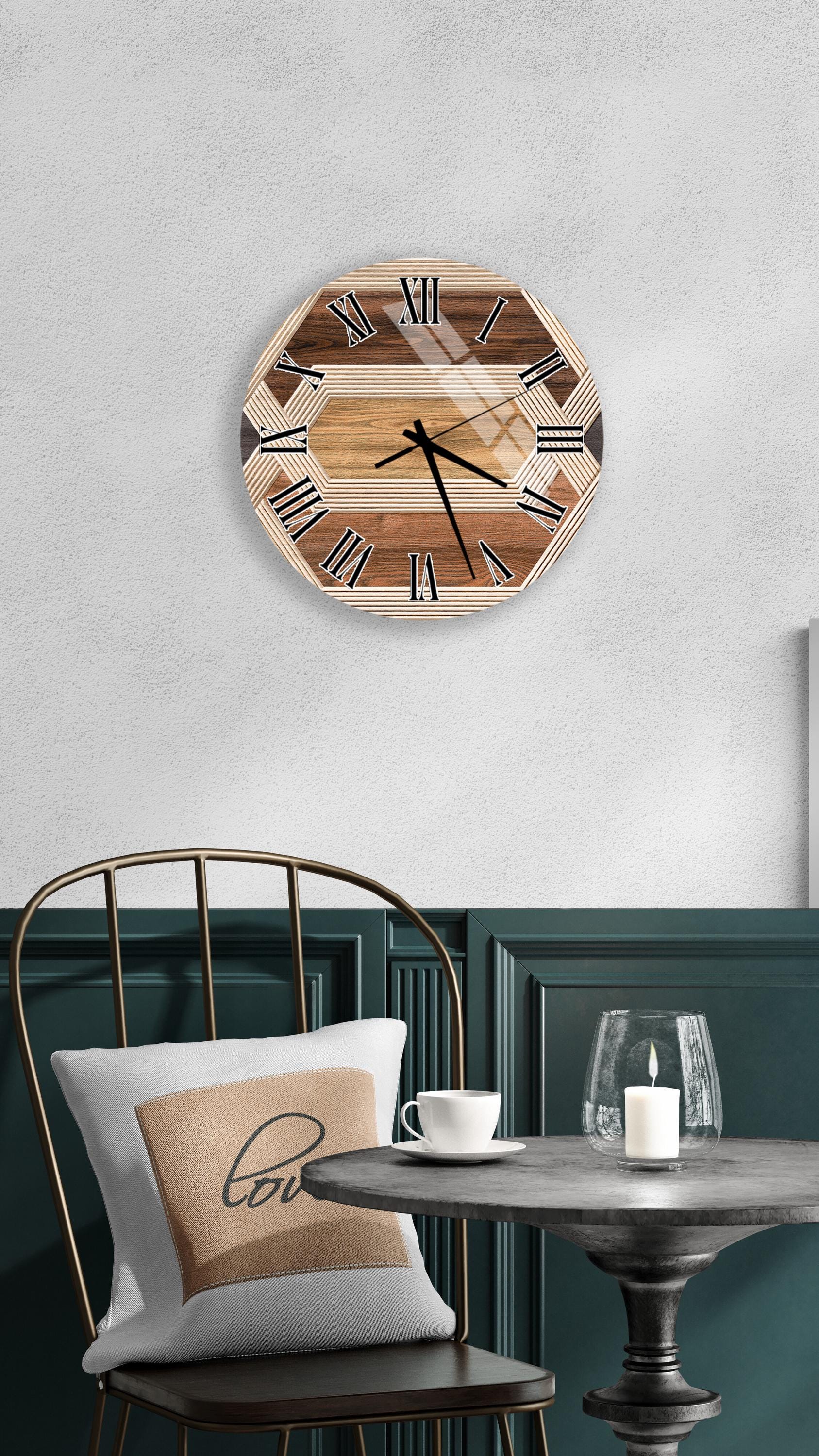 a wooden clock with Roman numerals mounted on a wall above a table with a white tablecloth and a candle.