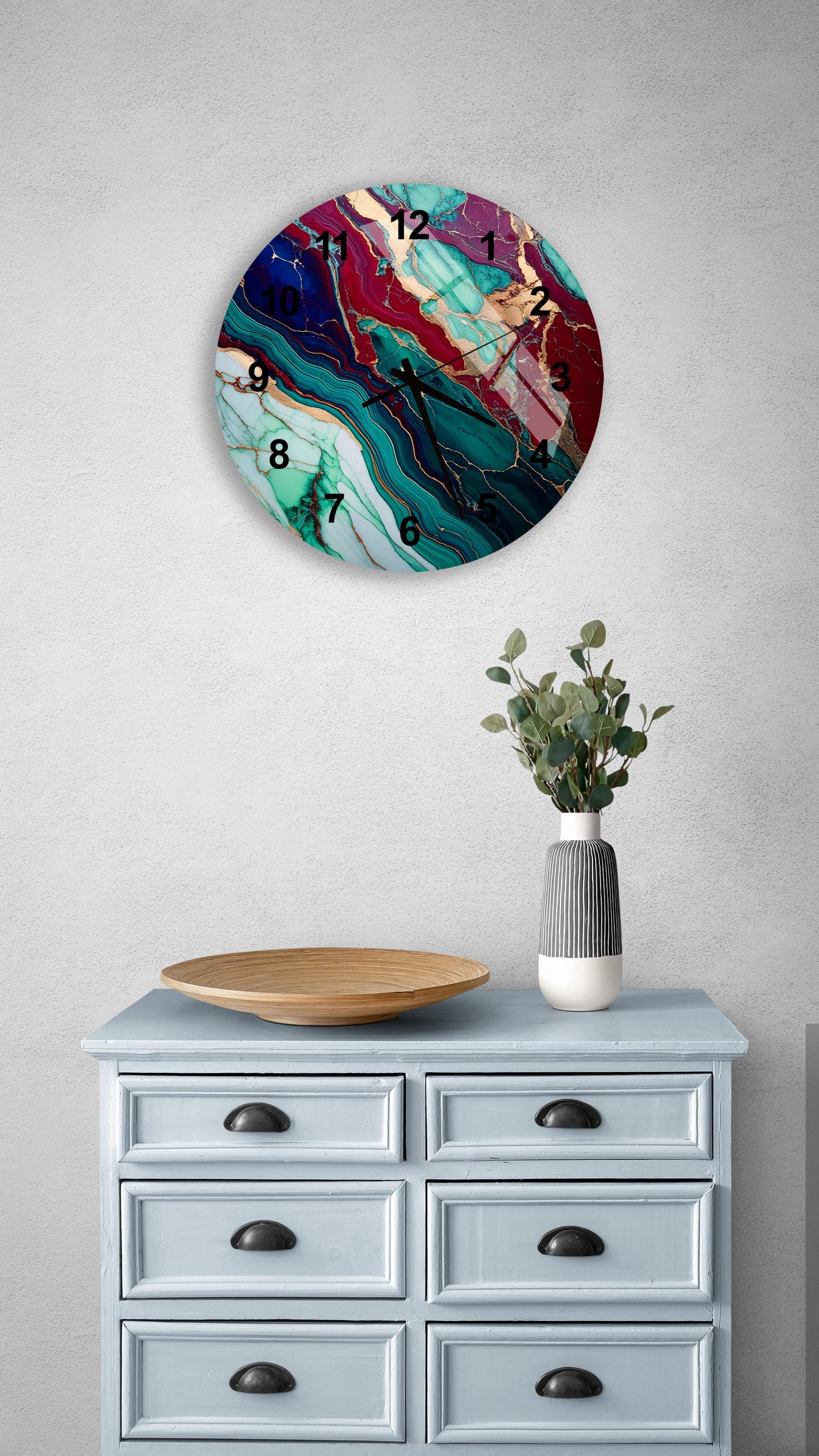 a blue dresser with a vase and a clock on it