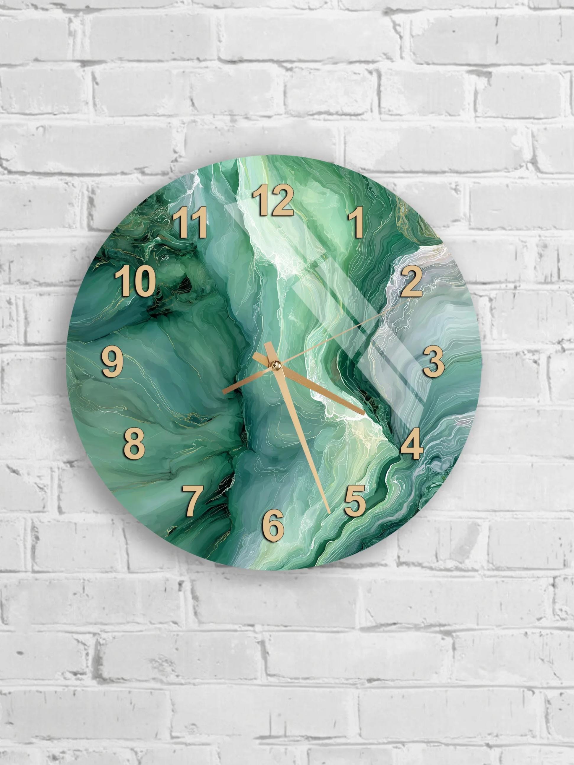 A round wall clock with a marble-like green and white pattern on its face, mounted on a white brick wall.