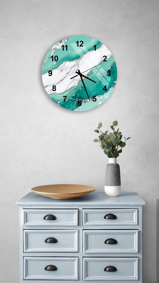 a wall clock with a turquoise marble design, mounted on a wall above a light blue dresser with six drawers. The dresser also has a vase with greenery on it, and a wooden bowl on top.