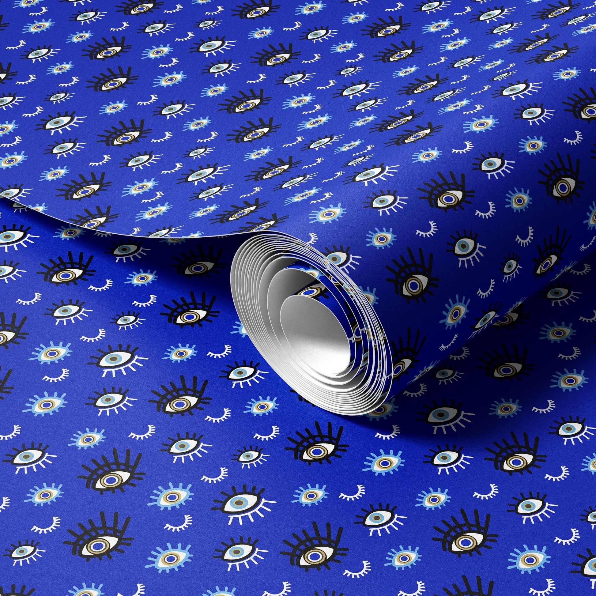 a roll of blue wrapping paper with a repeating pattern of black and white eyes on it.