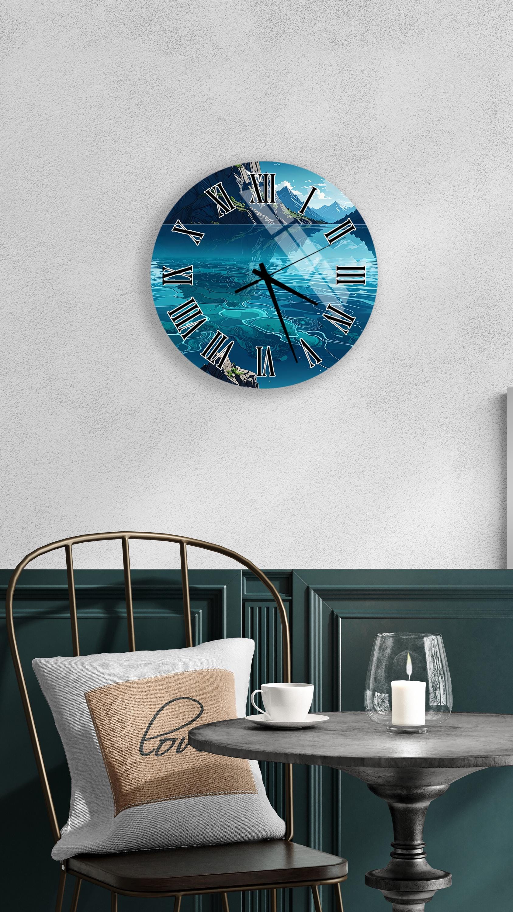 a wall clock with a blue ocean scene, a white table with a candle and a cup, and a black chair with a pillow.