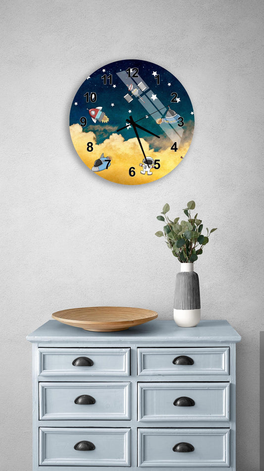 a clock with a space-themed design, mounted on a wall above a wooden dresser with drawers.