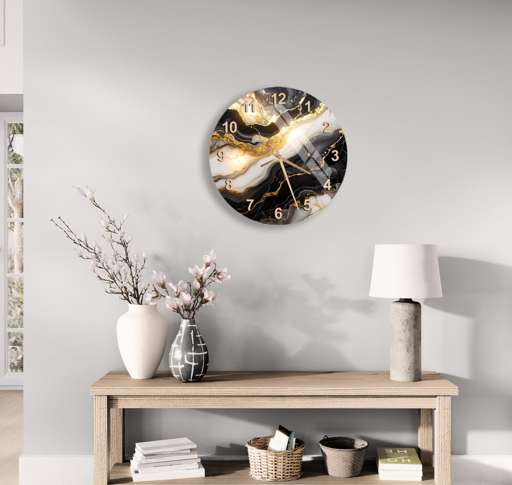 a modern living room with a wooden console table, a white vase with pink flowers, a black and white marble clock, and a white lamp.