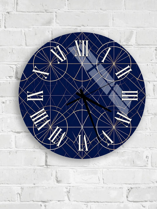 A round wall clock with a blue and gold geometric design, mounted on a white brick wall.