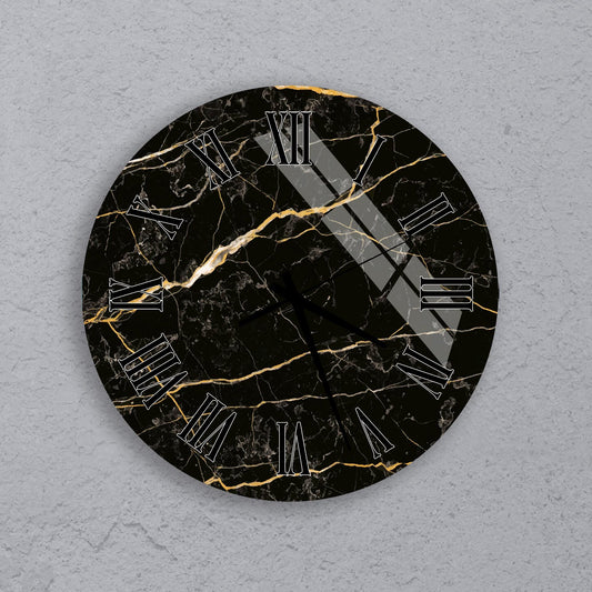 A black and gold marble-like clock face with Roman numerals.