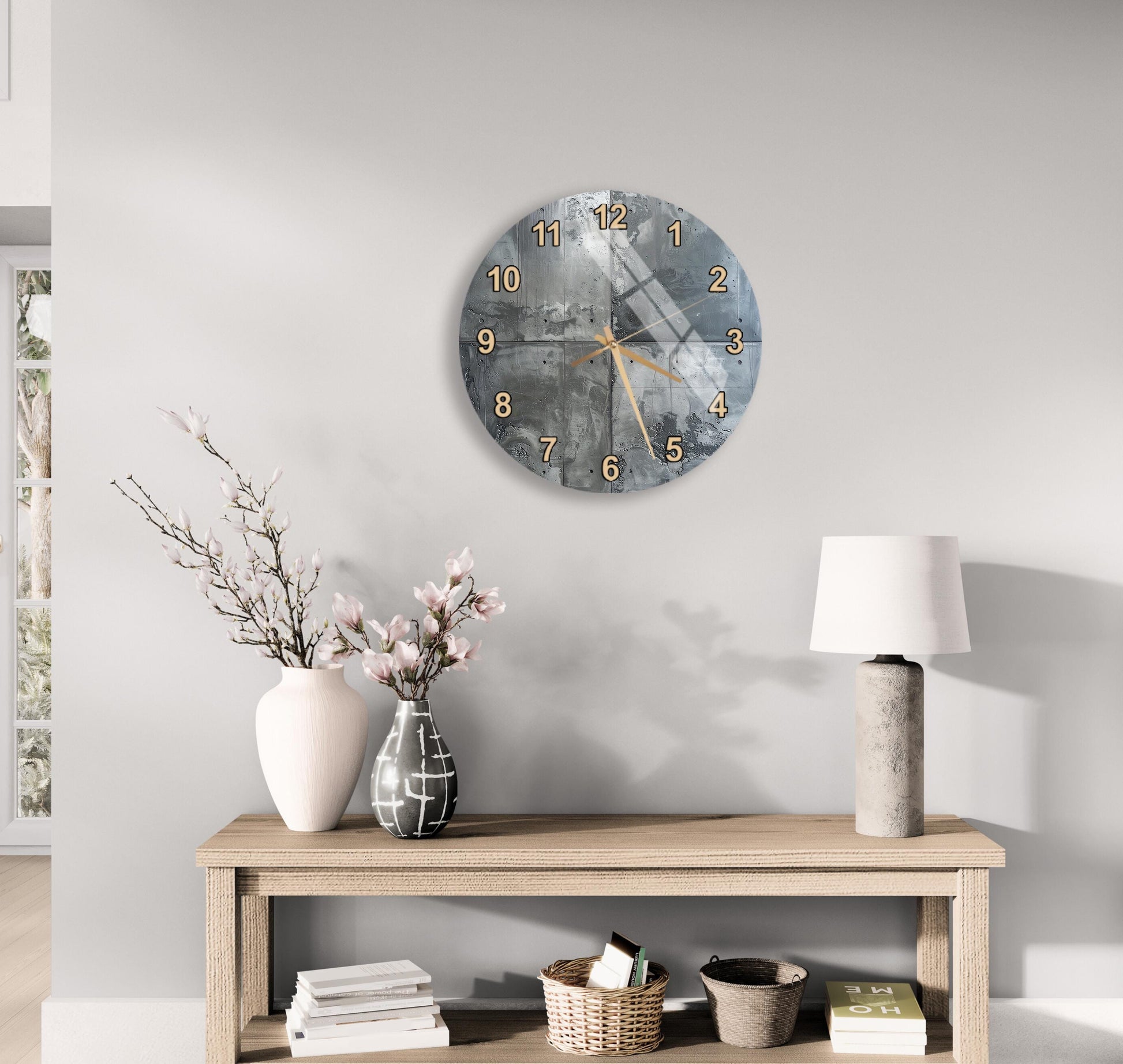 a modern living room with a wooden console table, a round wall clock, and various decorative items such as a vase with flowers, a lamp, and a stack of books.