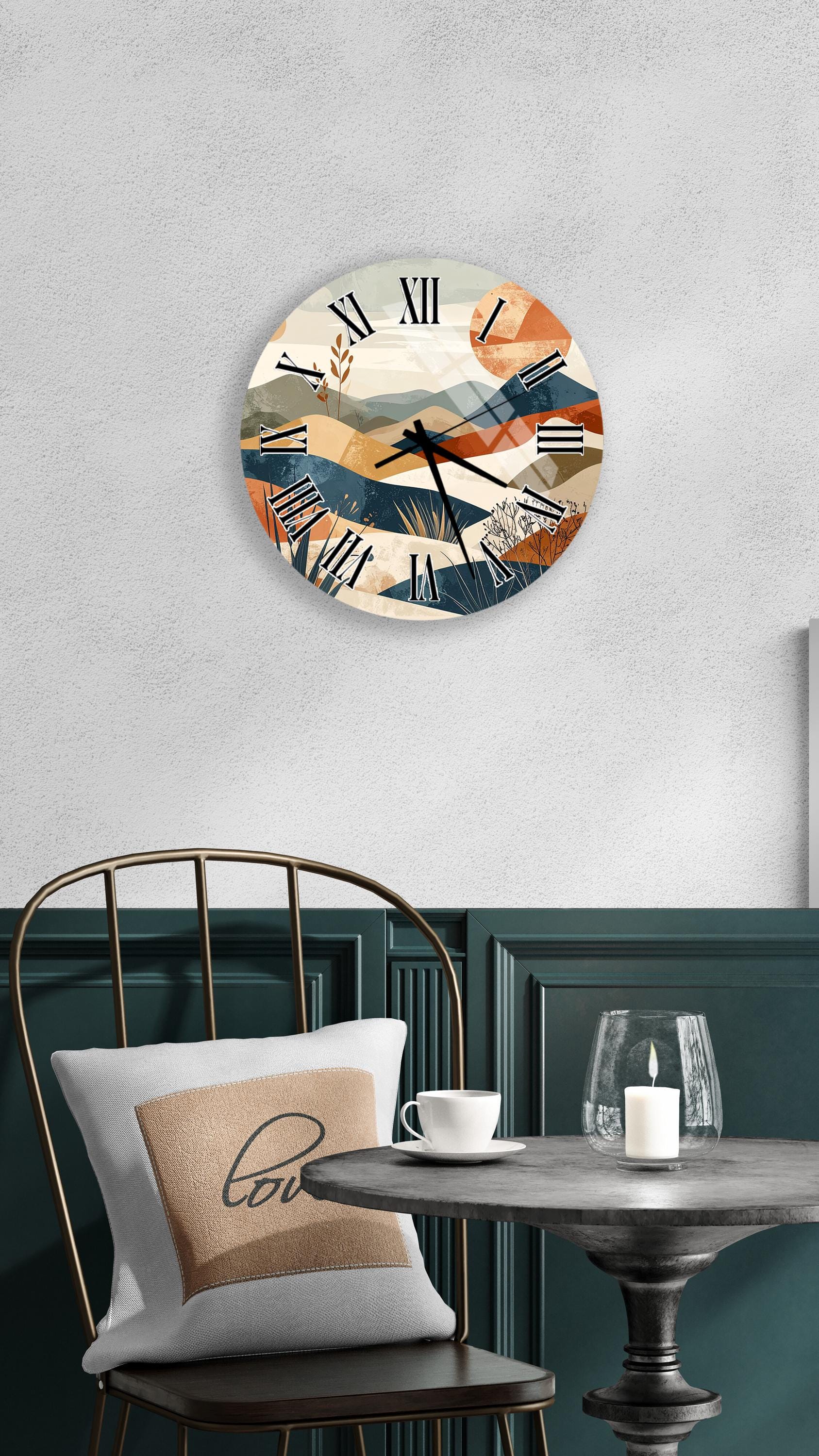 a modern interior design with a round wall clock displaying a desert landscape, a white table with a candle, and a black chair with a pillow.