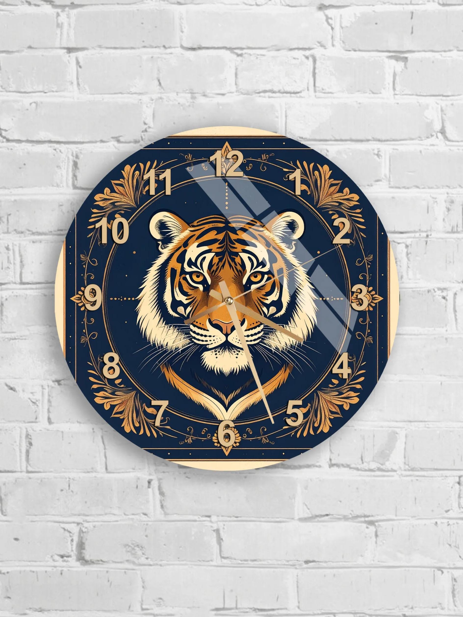 A wall clock with a tiger's face design on a dark blue background.