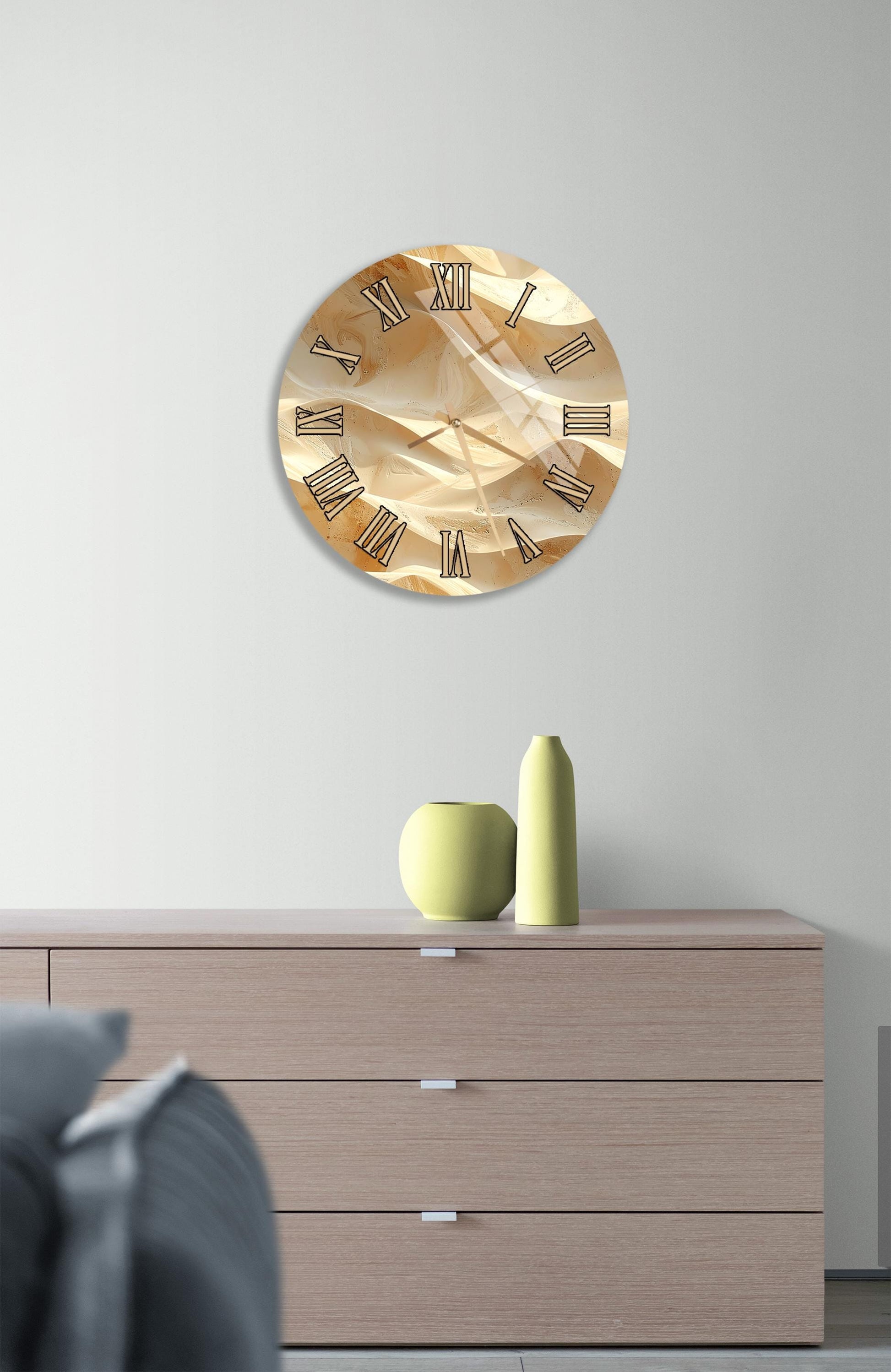 a modern living room with a wooden dresser, a round clock with a gold and brown design, and a green vase on the dresser.