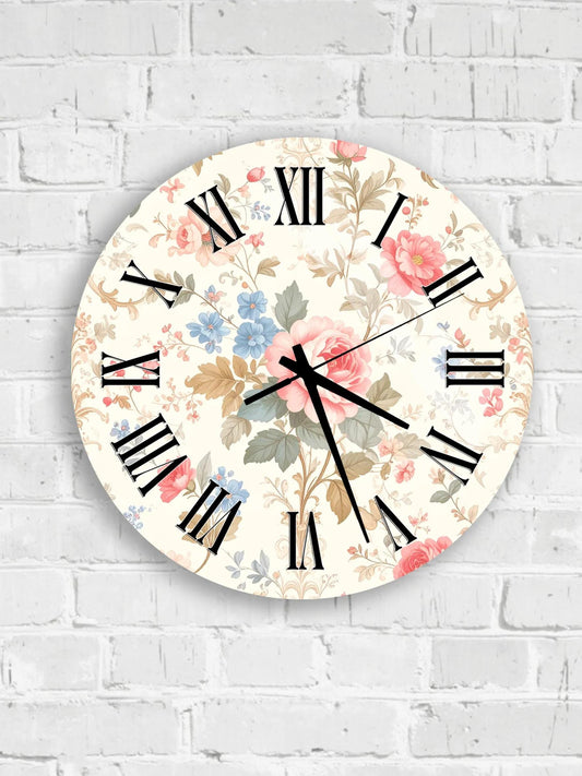 A round wall clock with a floral pattern on the face, mounted on a white brick wall.