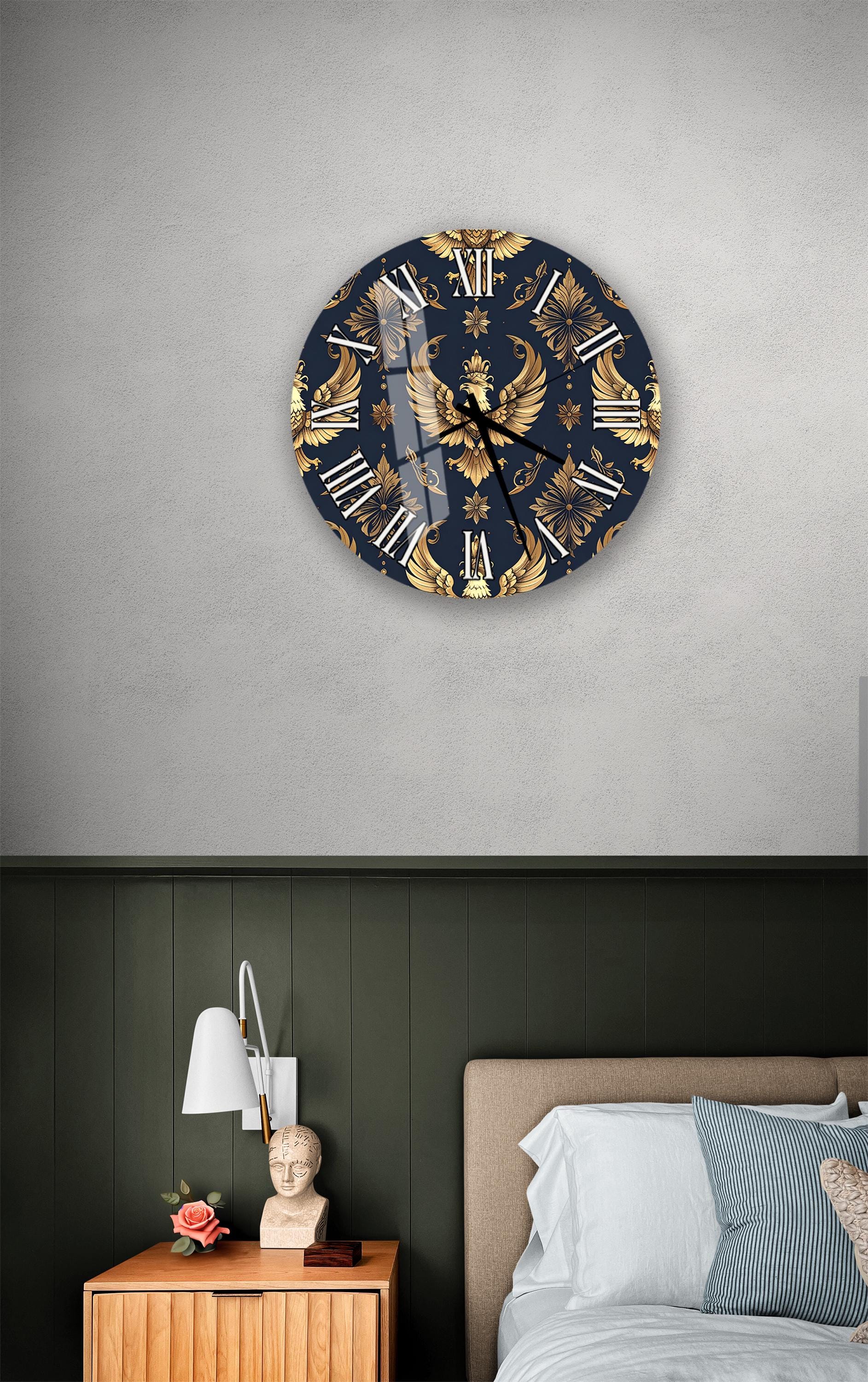 a bedroom setting with a large, ornate clock on the wall above a bed. The clock has a blue and gold design with a bird motif. The room has a dark green wall, a wooden nightstand with a lamp, and a bed with white sheets.