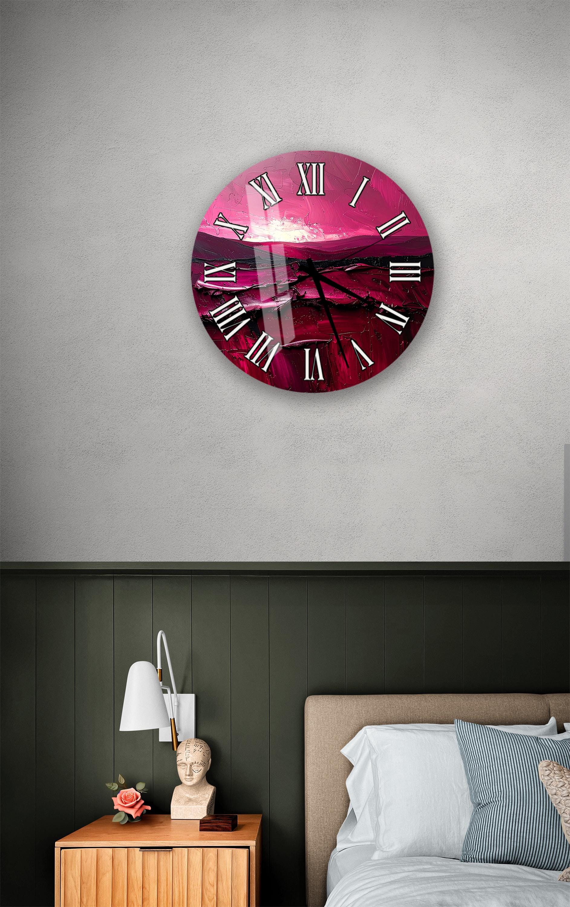 a bedroom setting with a large, round clock on the wall above a bed. The clock has a pink and purple color scheme and displays Roman numerals. The room also includes a nightstand with a lamp and a small statue or bust.