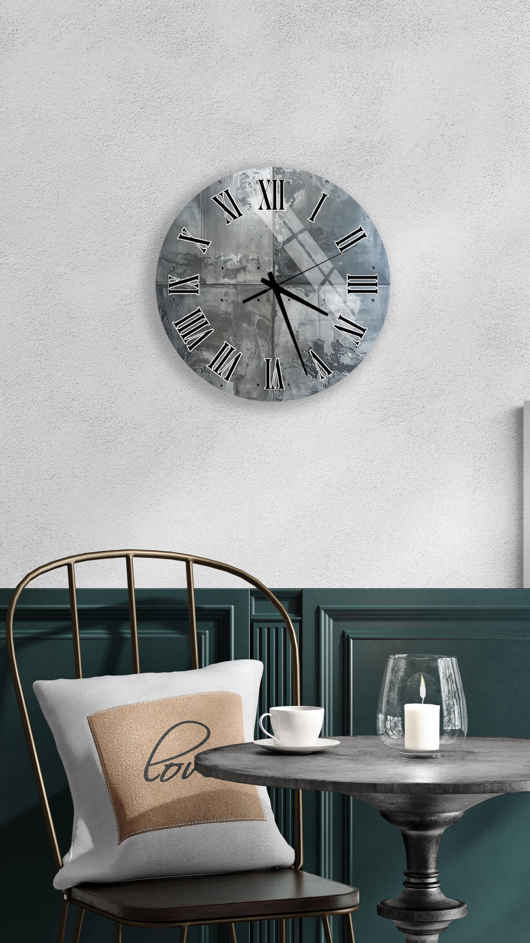 a modern and minimalist interior design with a large wall clock, a round table with a white tablecloth, and a gold chair.