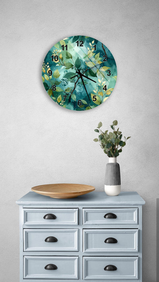 a wall clock with a green and white floral design, mounted on a wall above a light blue dresser with six drawers. The dresser also has a vase with greenery and a wooden tray on top.
