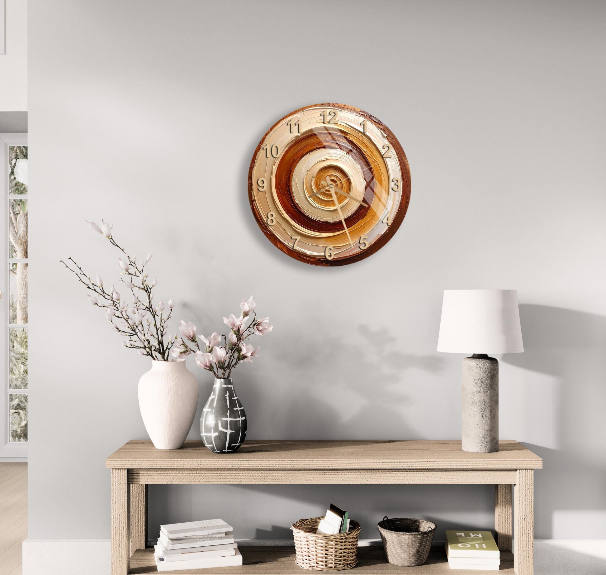 a wooden table with a clock, a vase with flowers, and a lamp on it, set against a light gray wall.