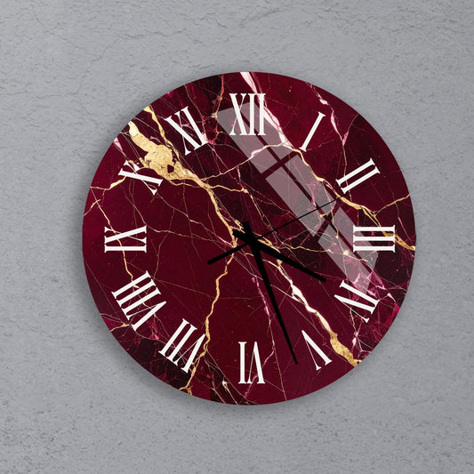 A round wall clock with a maroon and gold marble design, featuring Roman numerals and a cracked texture.