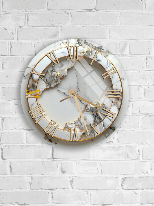 A white marble clock with gold Roman numerals is mounted on a white brick wall.