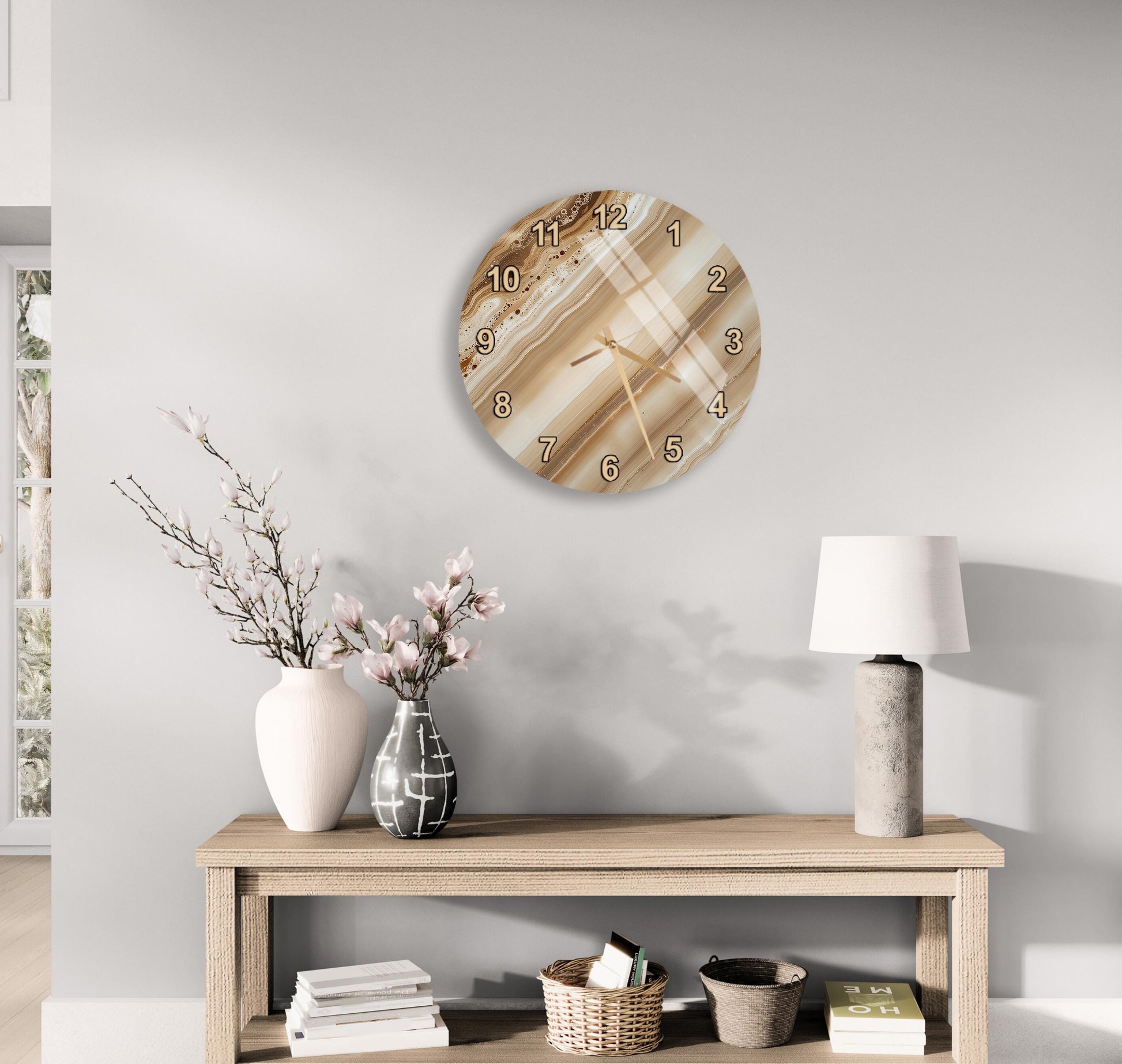 a modern living room with a wooden console table, a round wall clock, and various decorative items such as a vase with flowers, a lamp, and a stack of books.