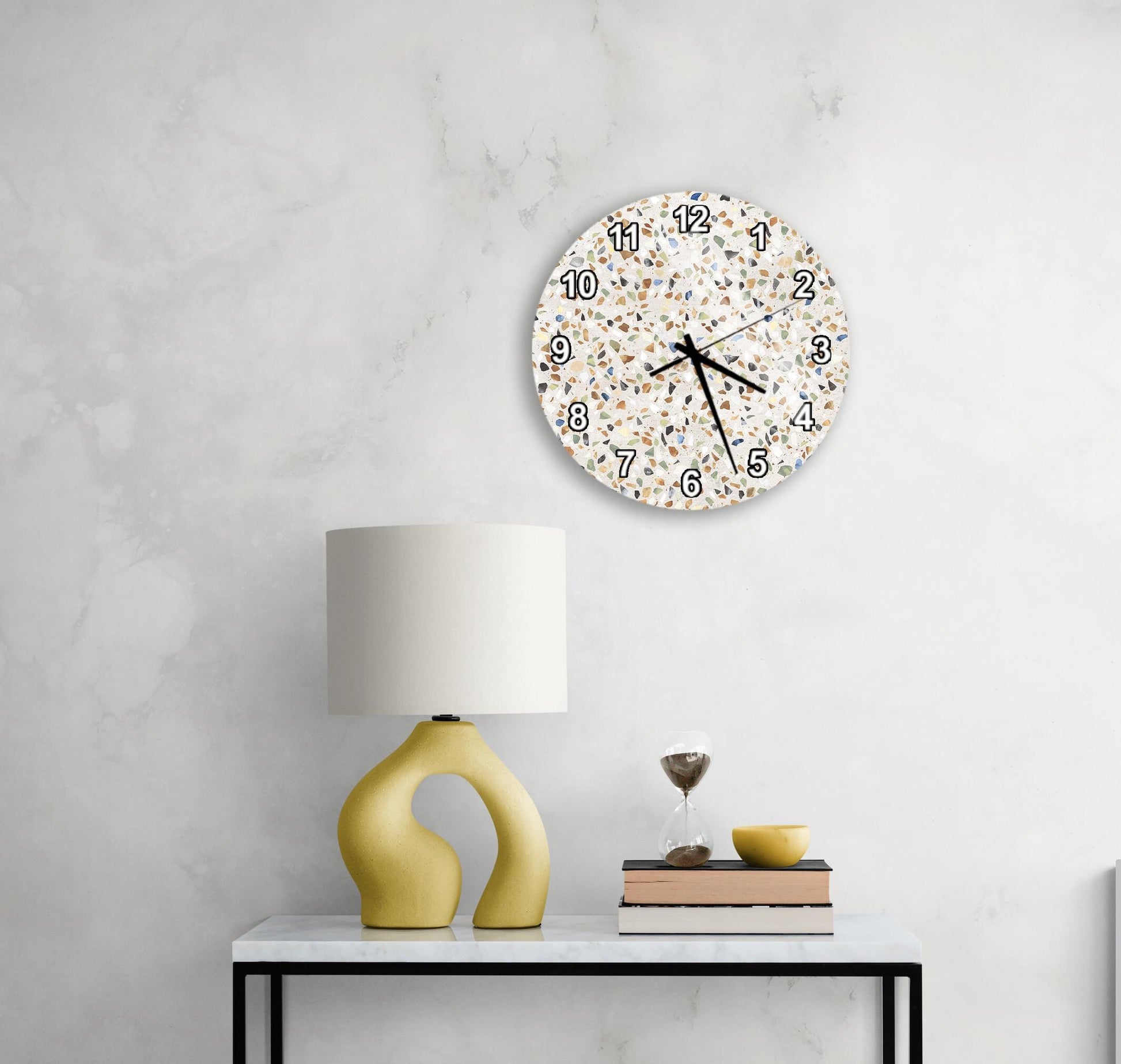 a modern and minimalist interior design with a round wall clock, a yellow lamp, and a white table.