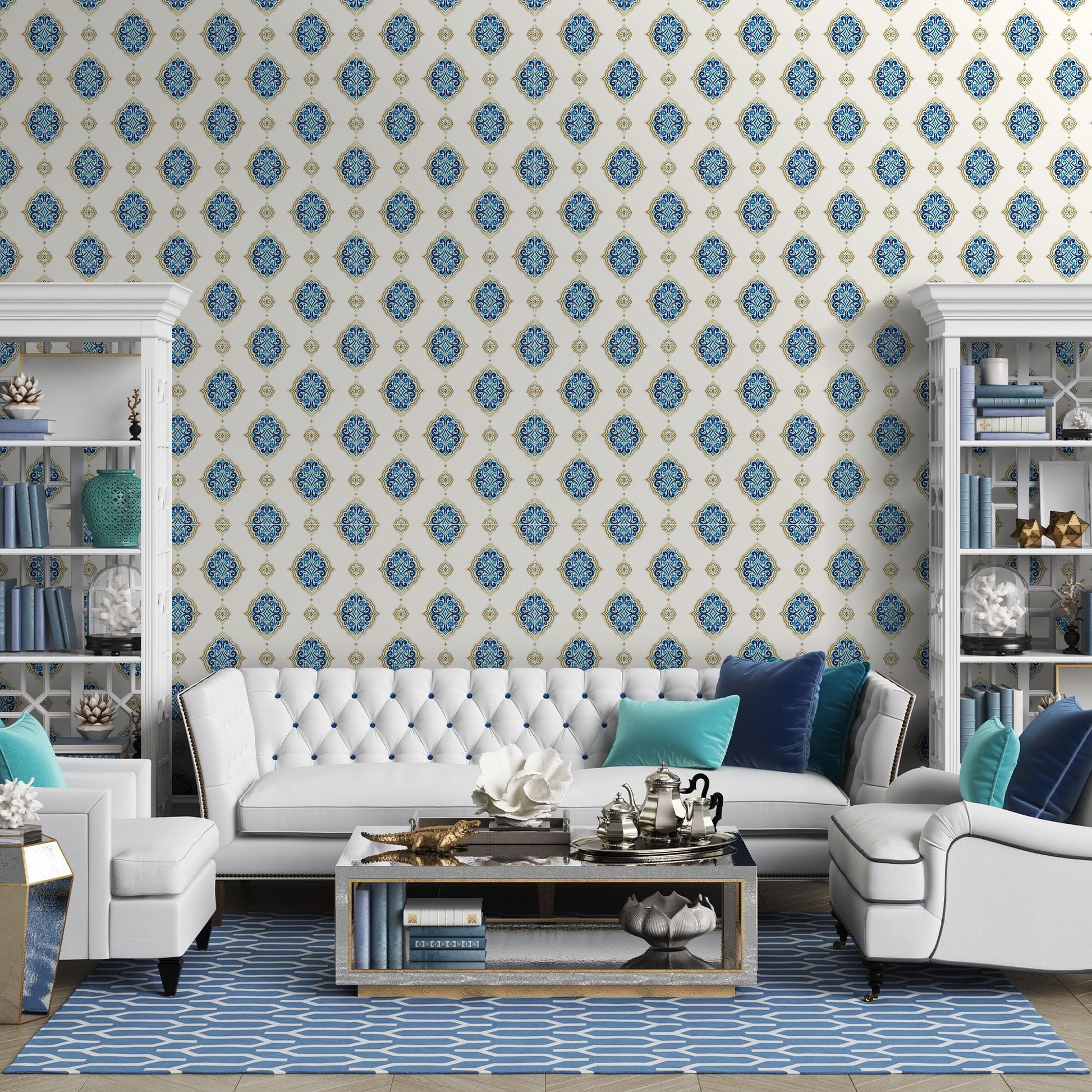 a modern living room with a white tufted sofa, a white armchair, and a glass coffee table. The room is decorated with blue and white patterned wallpaper, and there are several bookshelves and decorative items, such as vases and figurines, adding to the overall aesthetic.