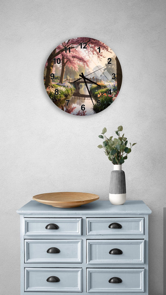a clock with a floral design on the face, mounted on a wall above a light blue dresser with drawers.
