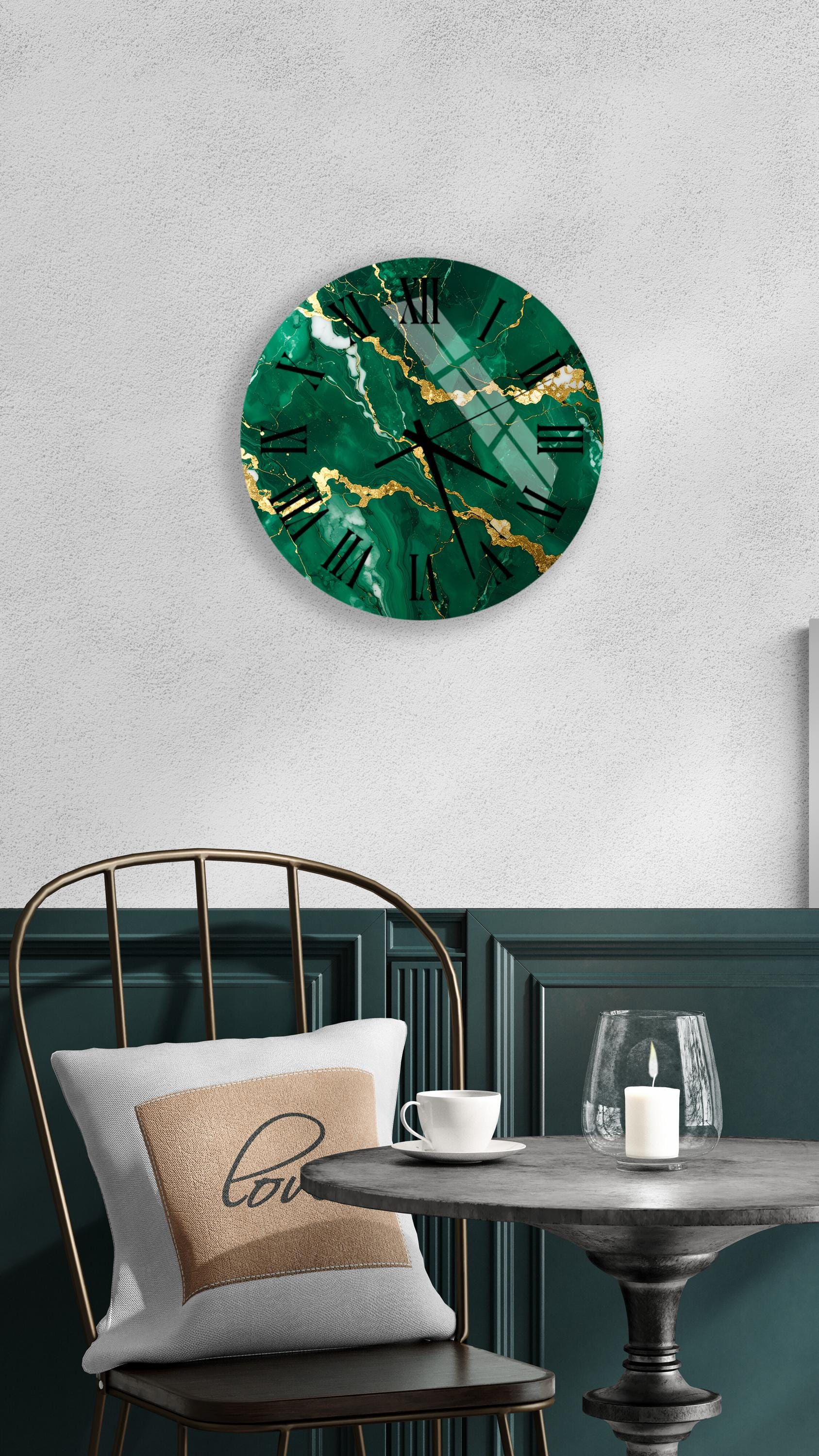 a modern and stylish interior design with a large green marble clock hanging on the wall above a dining table with a white tablecloth. The table is set with a white cup and a candle, creating a cozy and inviting atmosphere.