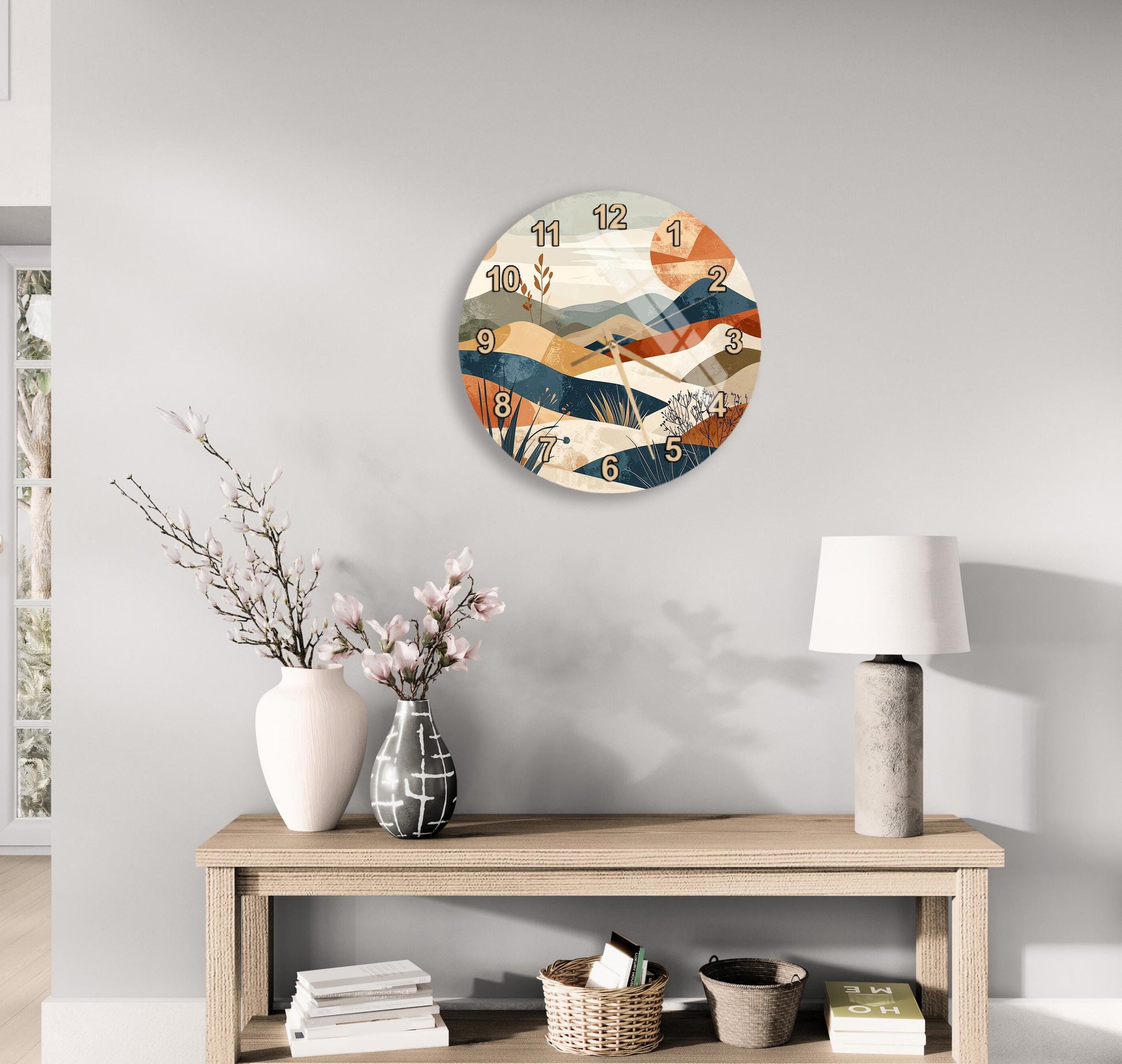 a modern living room with a wooden console table, a round wall clock with a colorful abstract design, a white vase with pink flowers, and a white lamp on a side table.