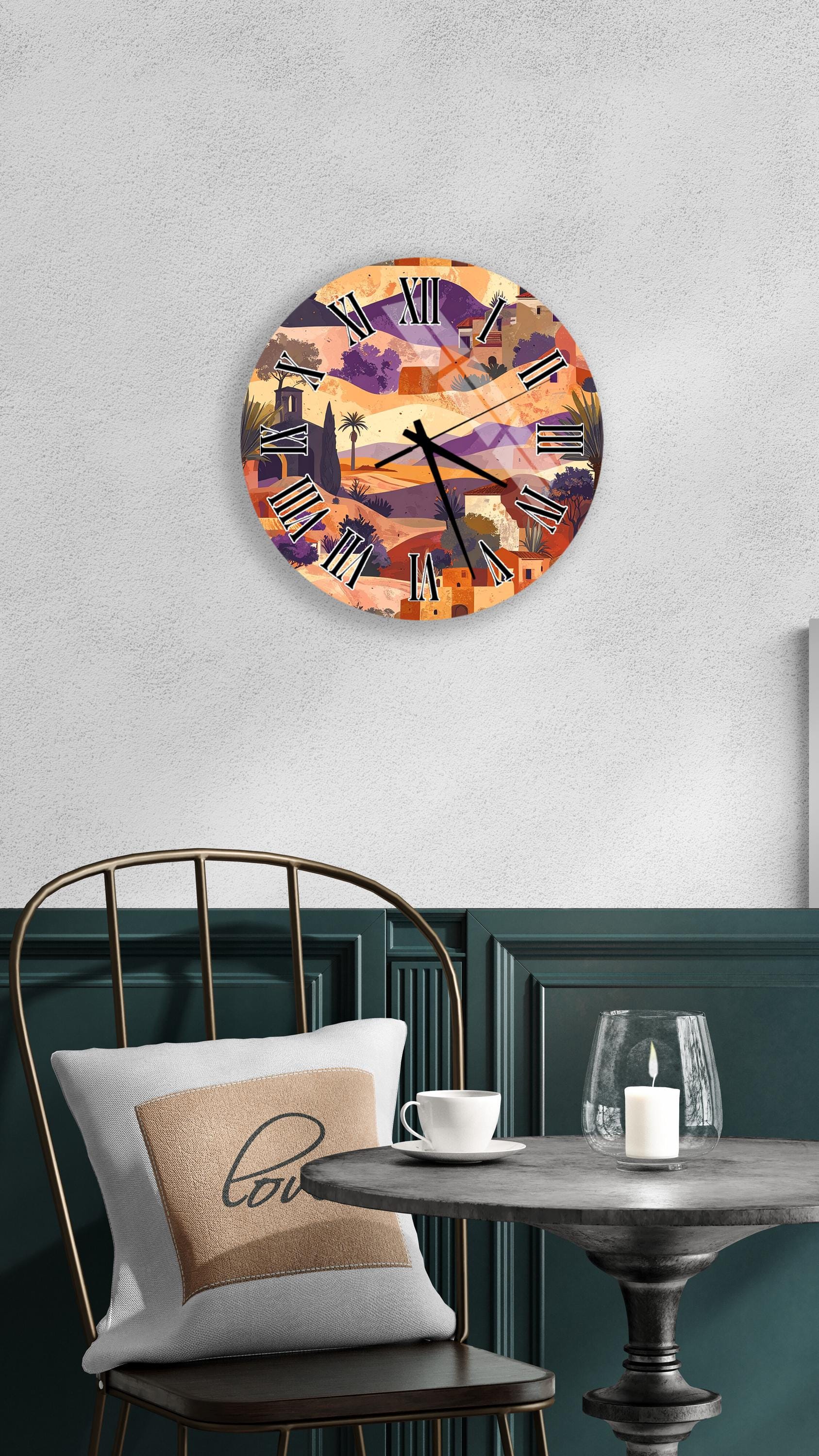 a wall clock with a colorful, abstract design, a table with a white candle and a cup, and a chair with a pillow.