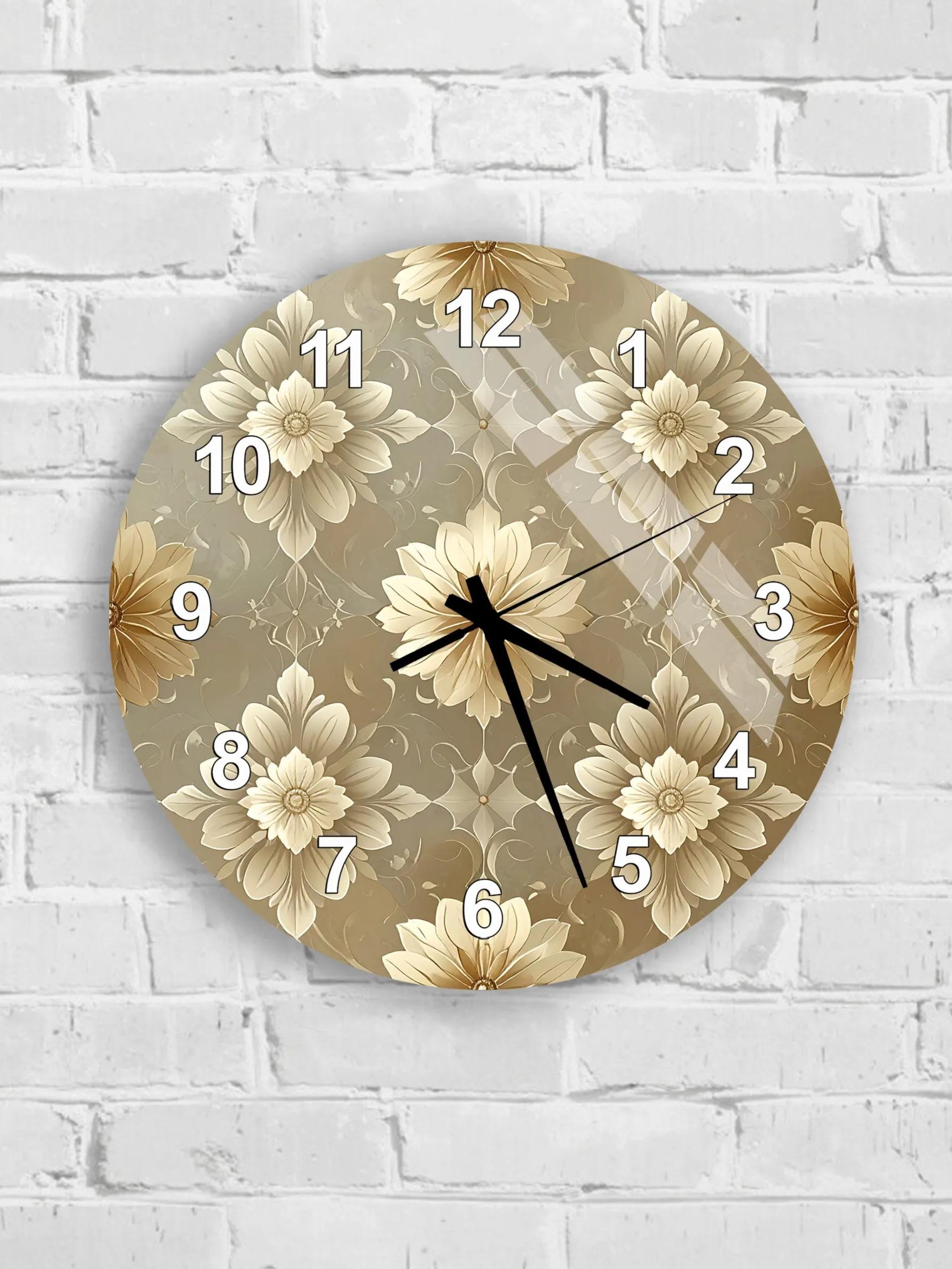 A round wall clock with a floral pattern on its face, mounted on a white brick wall.
