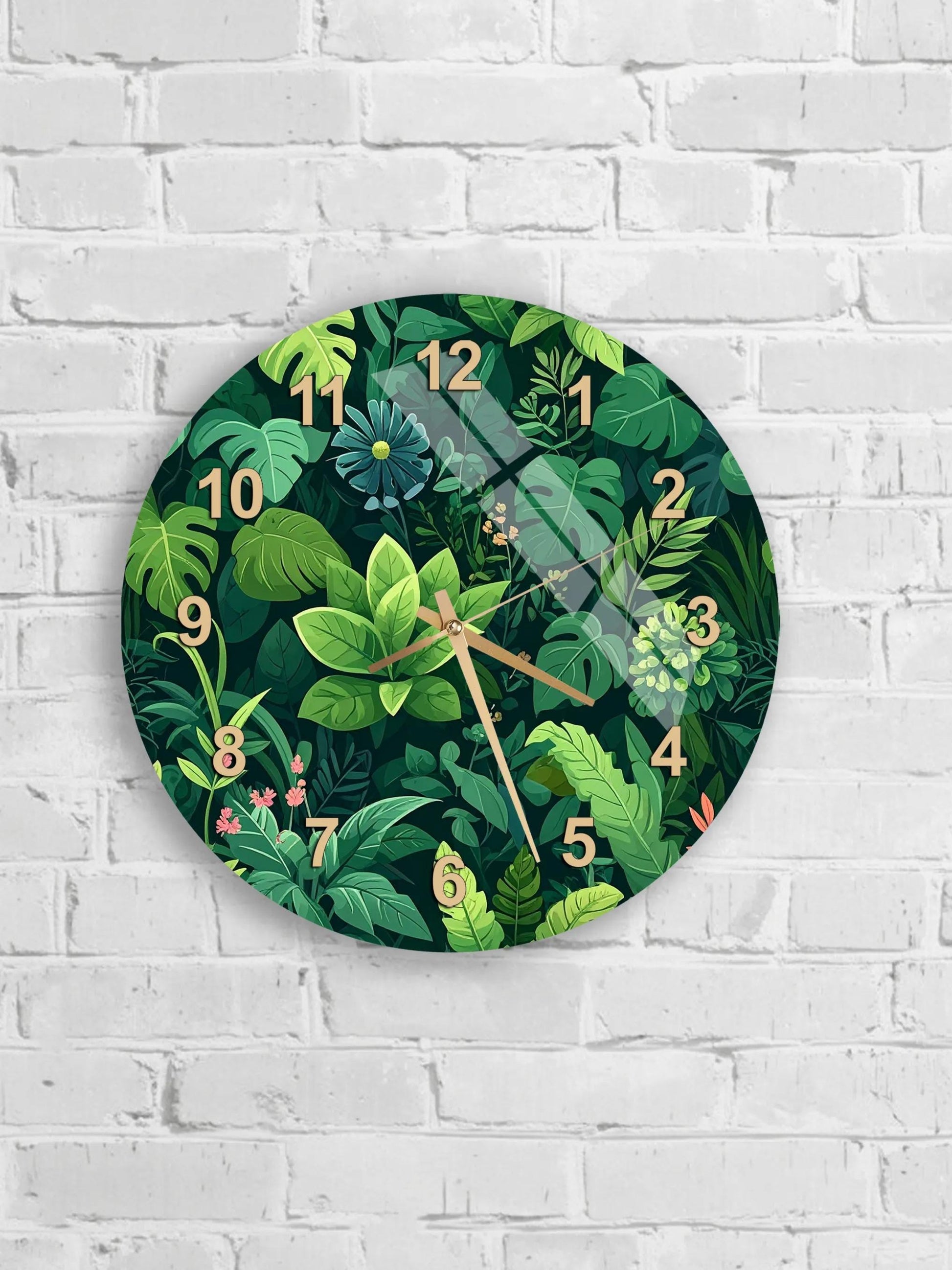 A round wall clock with a tropical plant design, featuring green leaves, flowers, and a brown clock face with gold numbers and hands.