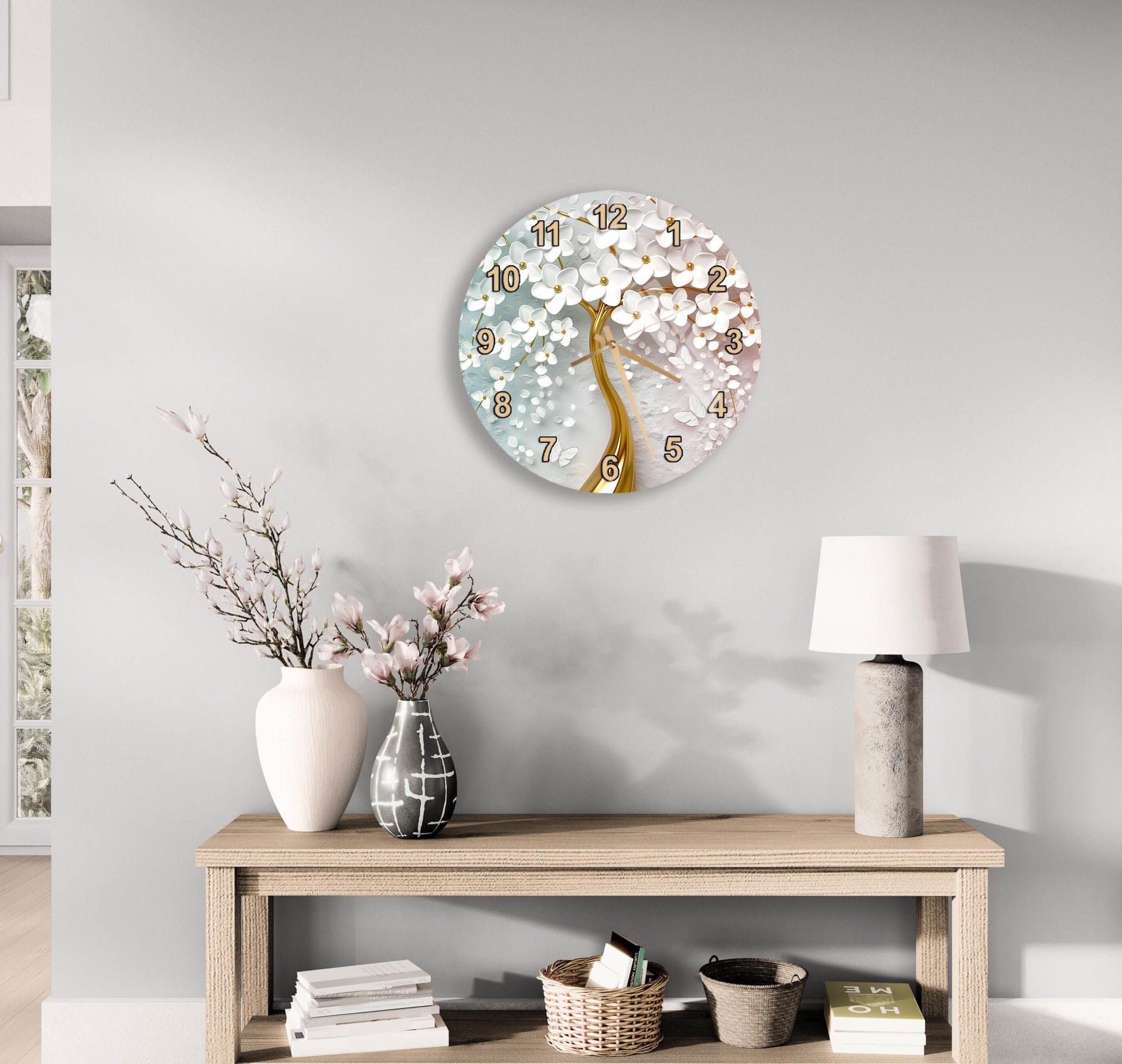 a wall clock with a floral design, a wooden table with a lamp, a vase with flowers, and some books on a shelf.