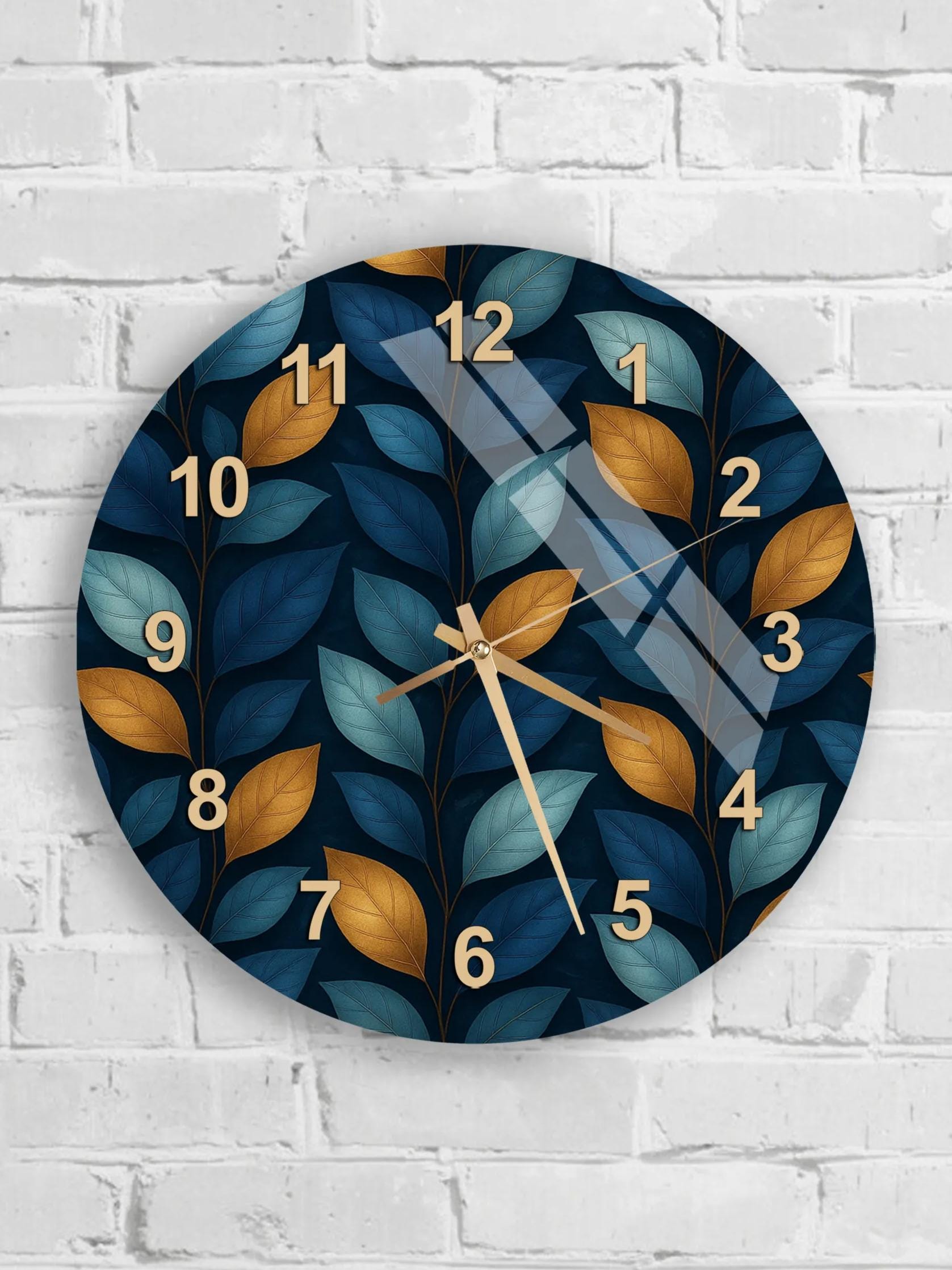 six round wall clocks with leafy leaf designs on a white brick wall.
