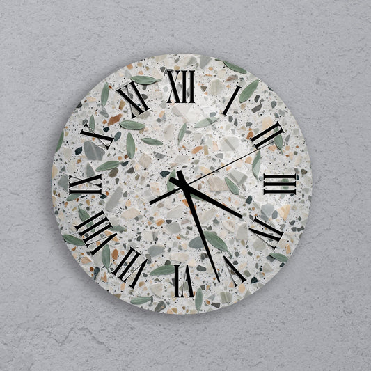 A round wall clock with a speckled, speckled pattern and Roman numerals on its face.