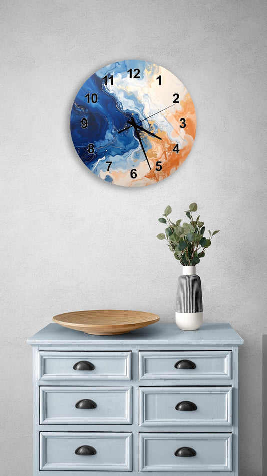 a wall clock with a blue and orange abstract design, mounted on a wall above a light blue dresser with six drawers. The dresser also has a vase with greenery and a wooden tray on top.