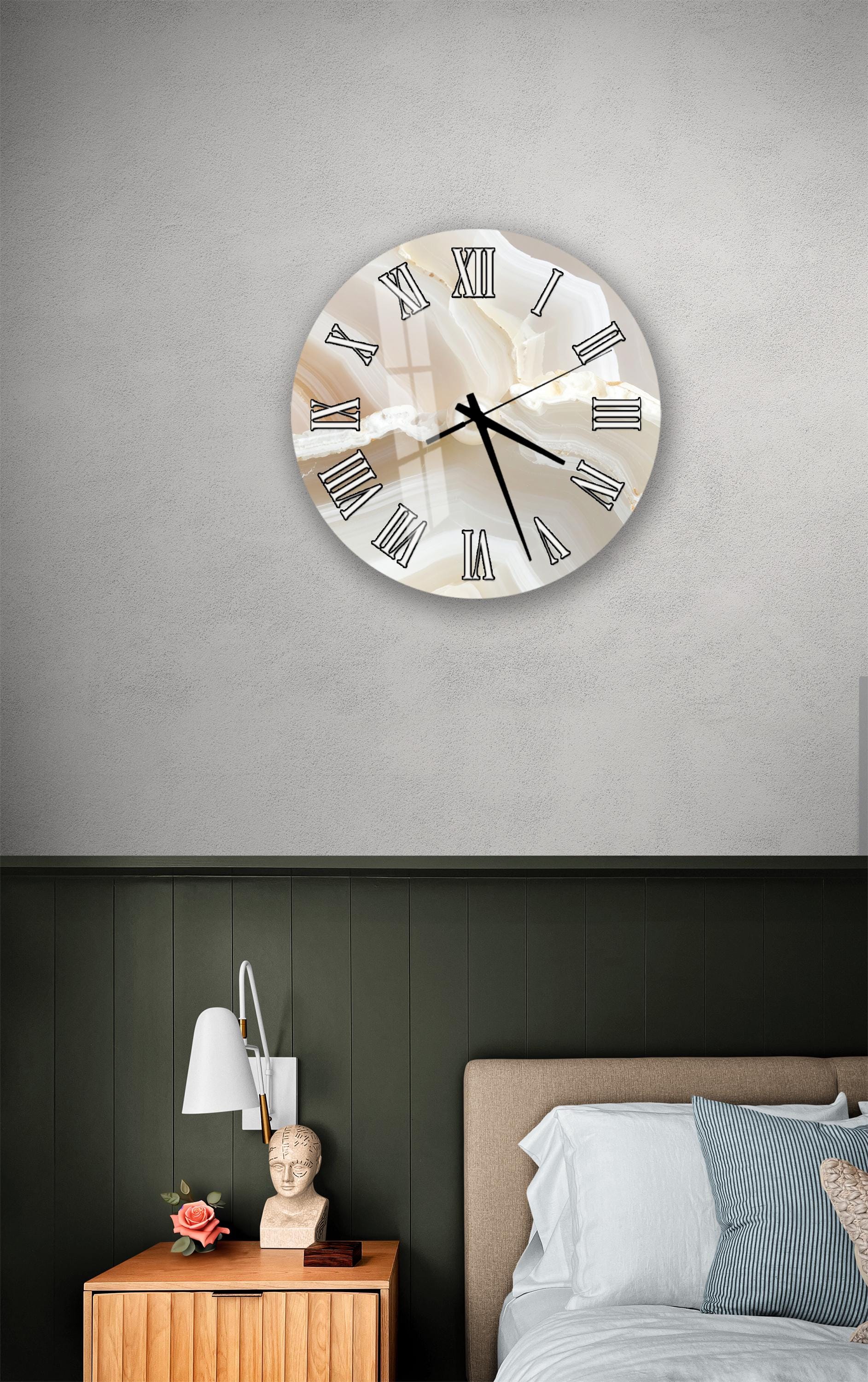 a bedroom setting with a large wall clock, a wooden nightstand, and a bed with white bedding.