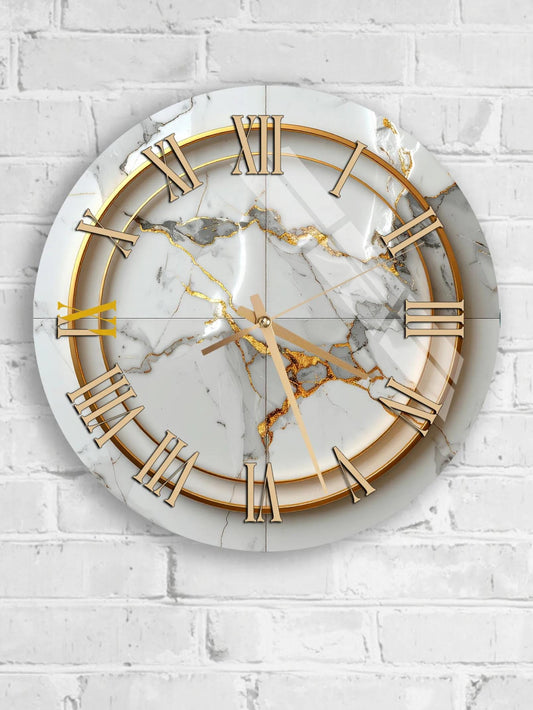 A white marble clock with gold Roman numerals is mounted on a white brick wall.